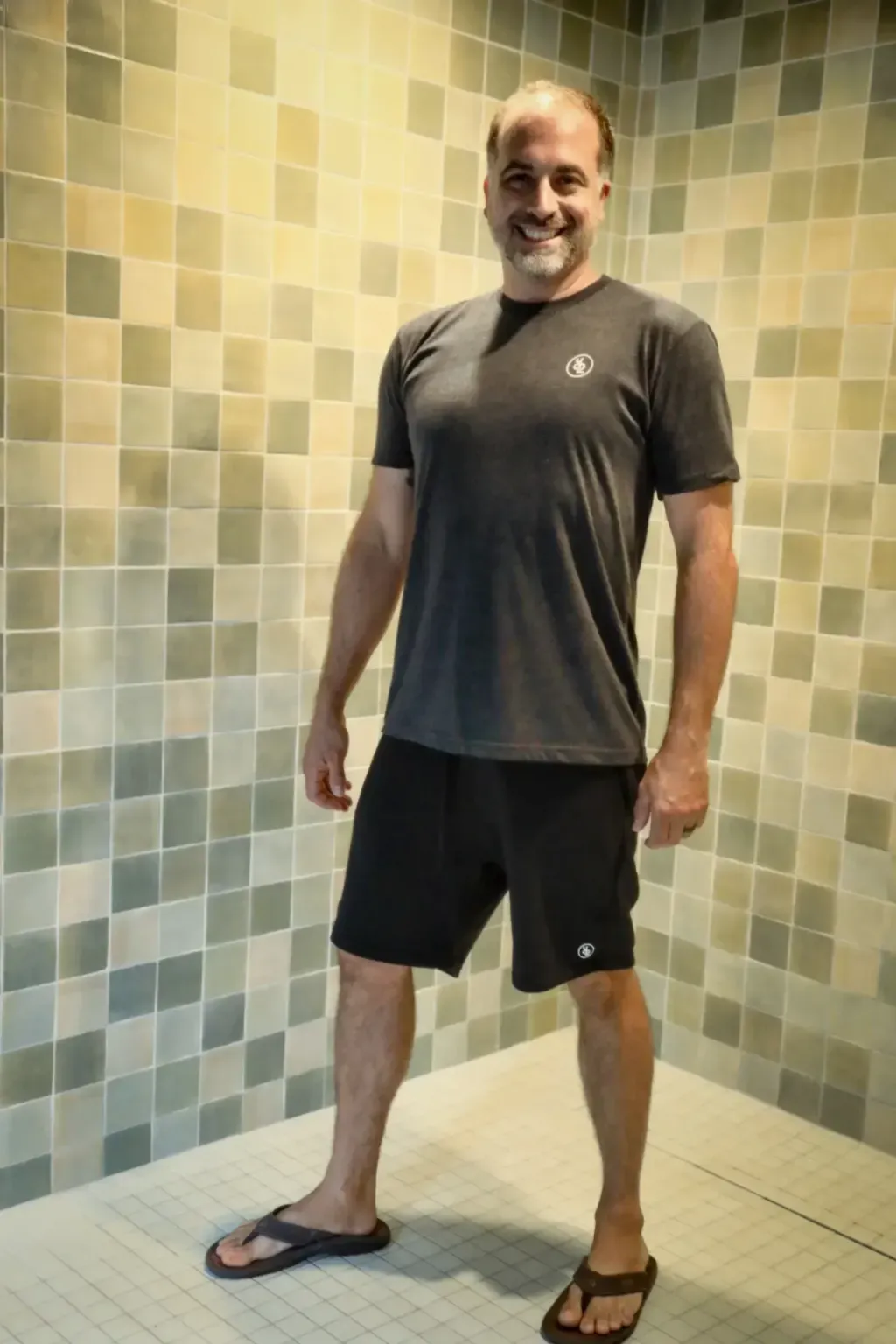 Tiled shower area at Sauna Culture for post-sauna rinses in Charlotte, NC