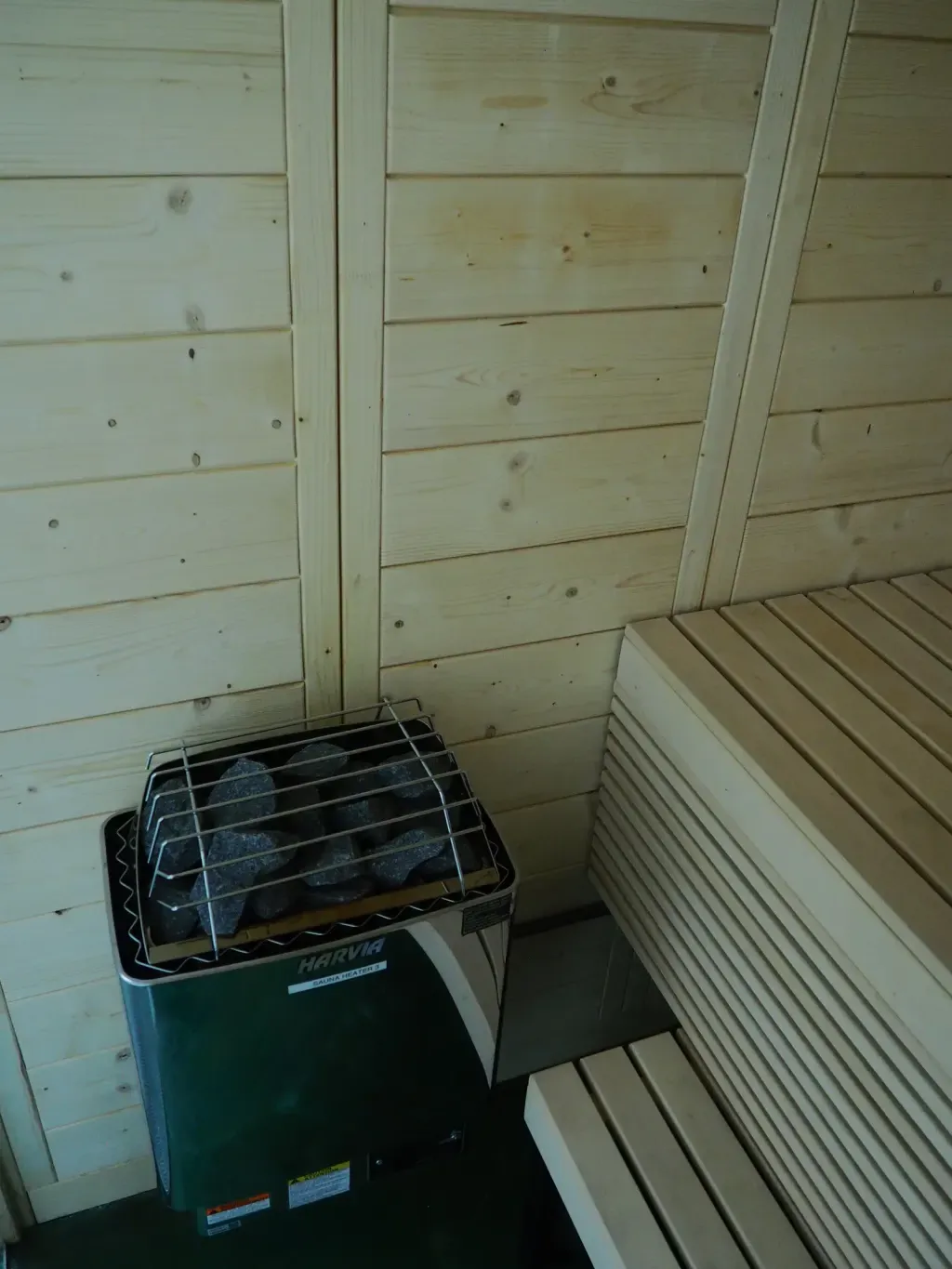 Wood-fired sauna stove ready for löyly at Sauna Culture's traditional Finnish sauna in Charlotte