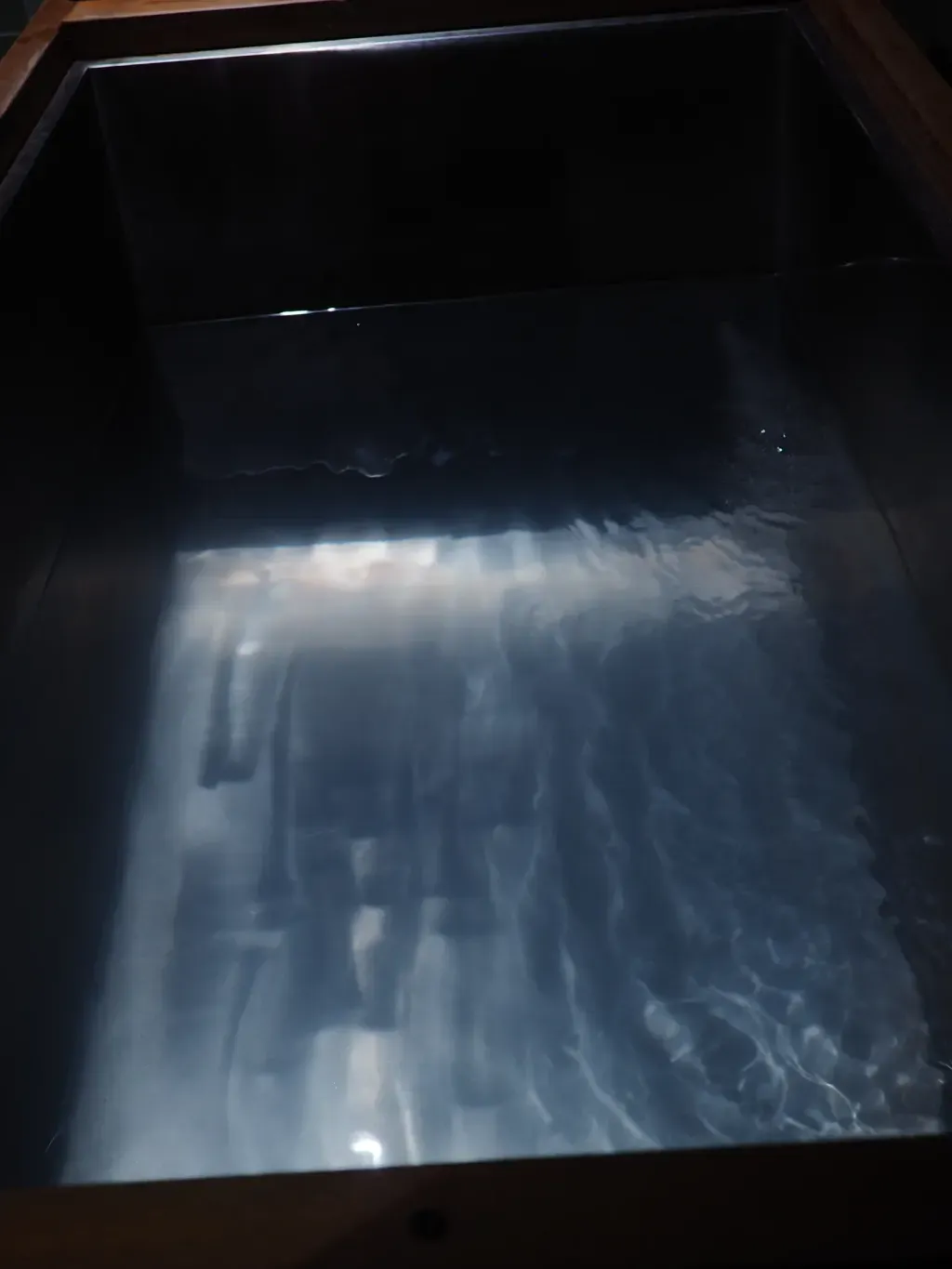 Cold-plunge water surface at Sauna Culture Charlotte — individual plunges held at controlled temperatures
