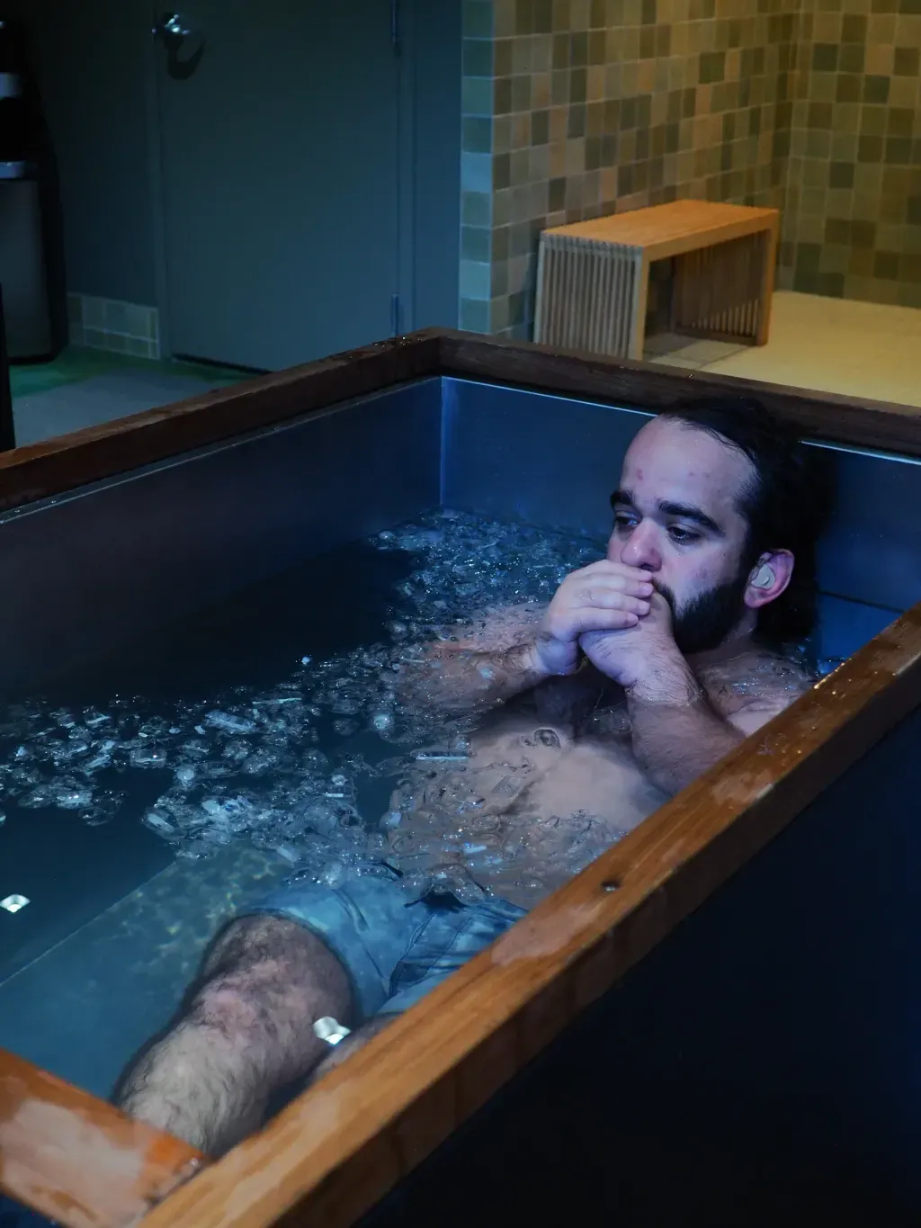 Athlete in an individual cold plunge for muscle recovery at Sauna Culture Charlotte