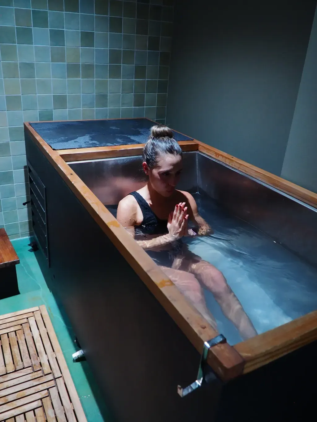Guest in quiet meditation in an individual cold plunge at Sauna Culture Charlotte