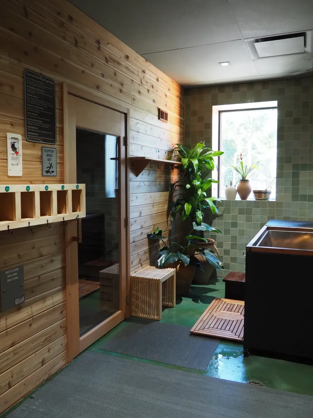 Wood-paneled sauna door at Sauna Culture Charlotte's Cotswold studio