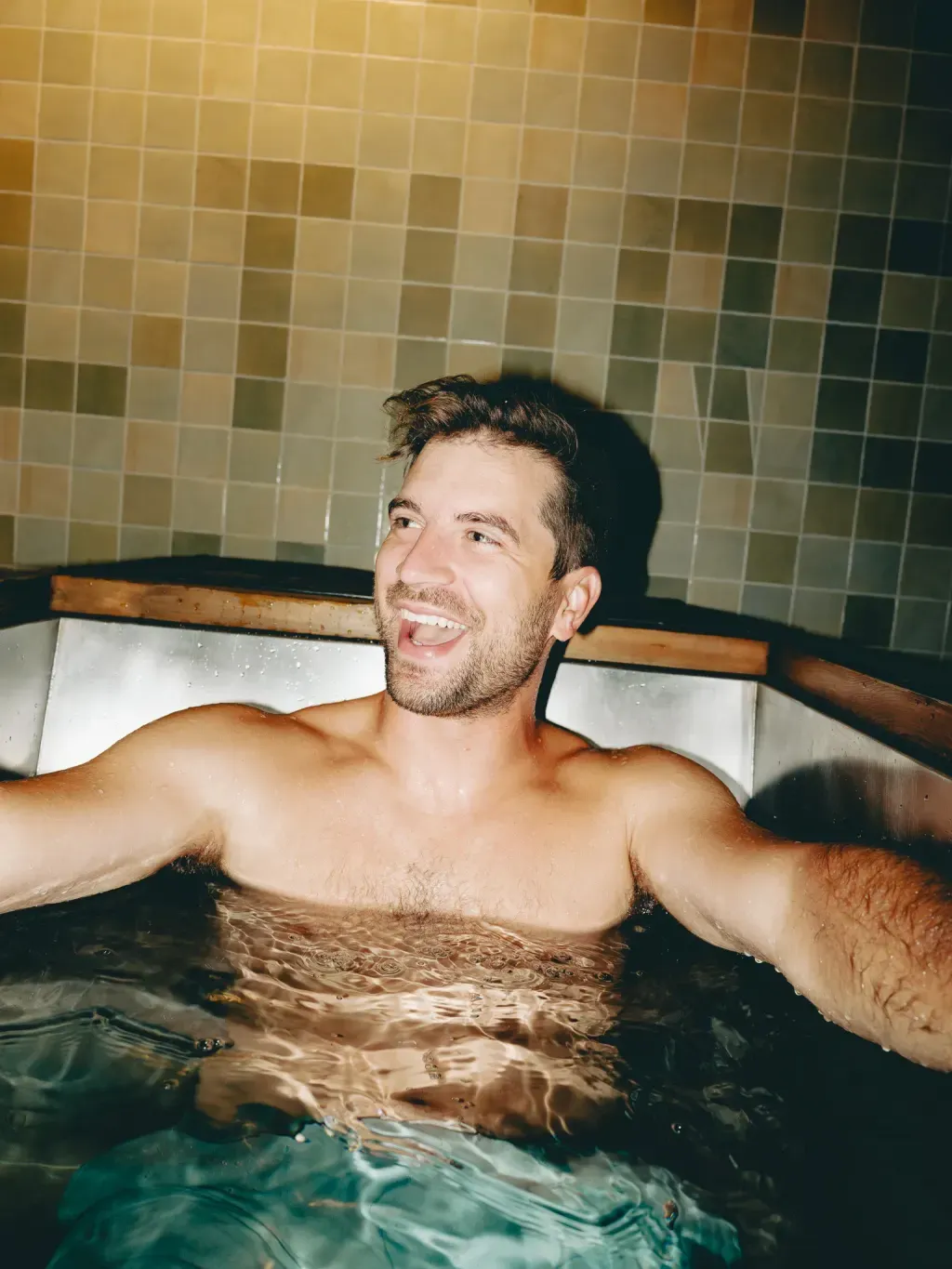 Guest laughing through a cold-plunge round at Sauna Culture Charlotte