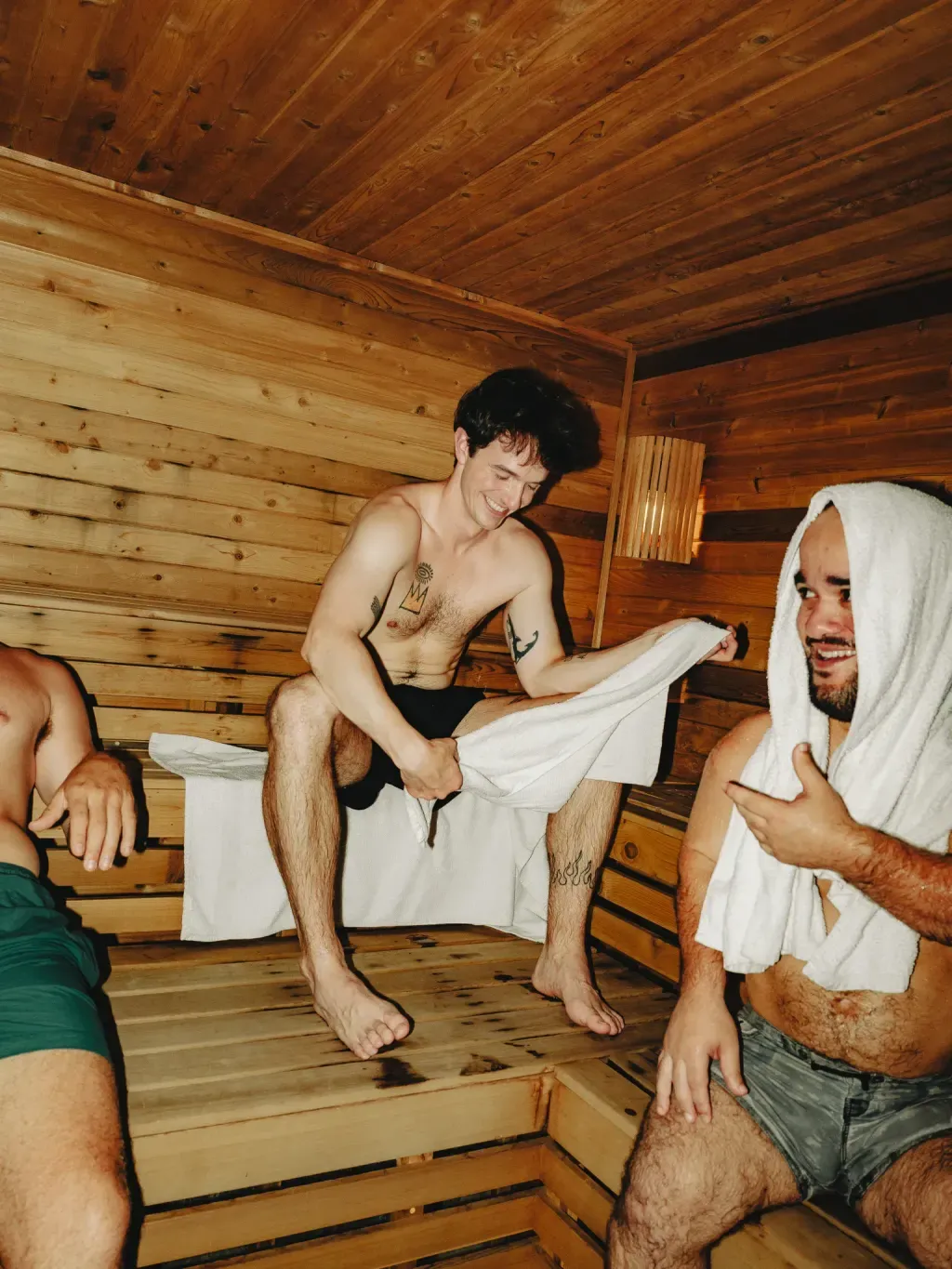 Three guests talking in the cedar Finnish sauna at Sauna Culture in Cotswold, Charlotte